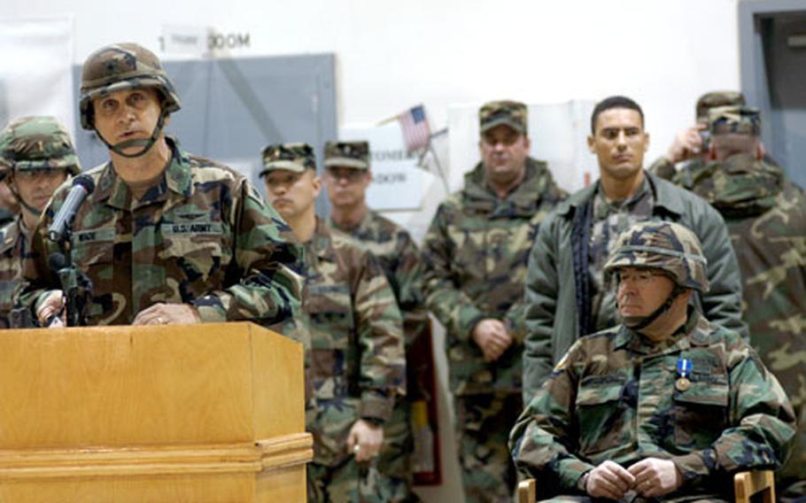 Brig. Gen. William H. Wade, left, incoming commander of the U.S. peacekeeping force in Kosovo, the Multinational Brigade (East), addresses troops at a transfer of authority ceremony Sunday at Camp Bondsteel.