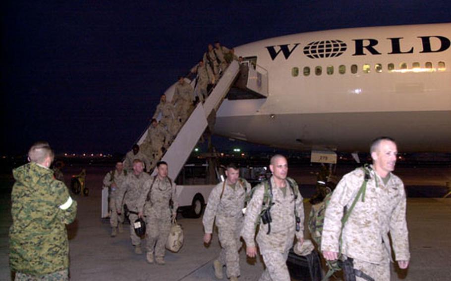 The 31st Marine Expeditionary Unit advance team members arrive at Kadena Air Base early Sunday morning after spending from six months to a year in Iraq.