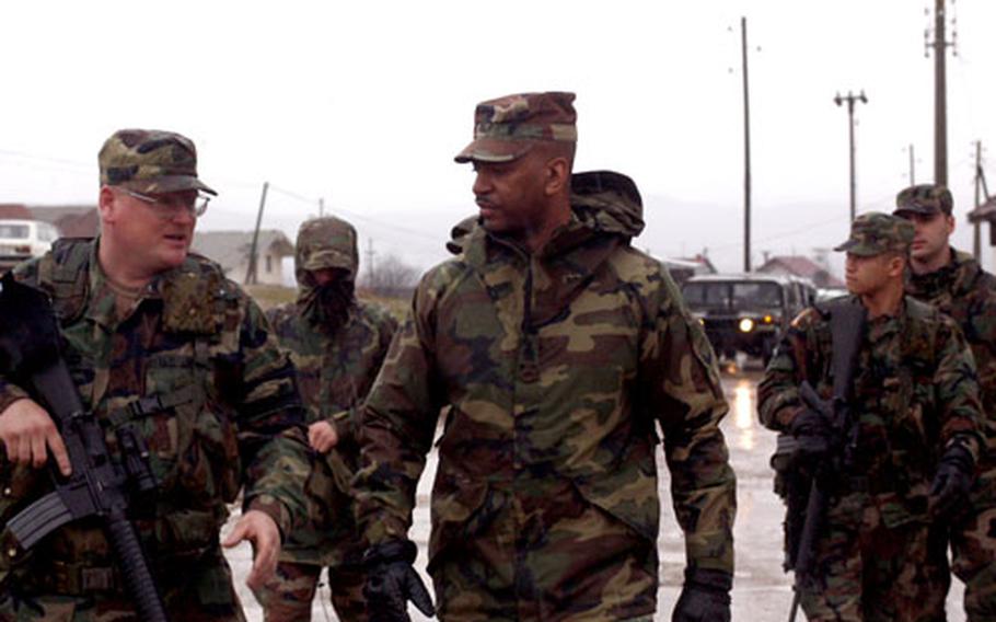 U.S. European Command’s Command Sgt. Maj. Michael Bartelle, center, talks with Staff Sgt. Phillip Hoover of the 1st Battalion, 160th Infantry Regiment, during a patrol of the Serbian town of Pasjan, Kosovo, on Saturday. Bartelle also visited troops at Camp Bondsteel and Camp Monteith over the weekend.