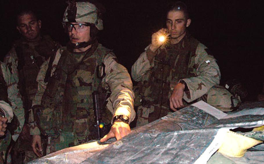 First Lt. Patrick Hein of Phoenix City, Ala., the platoon leader, maps out a plan of action for Sunday night&#39;s patrol with Sgt. Christopher Rogers, right, of Sacramento, Calif.