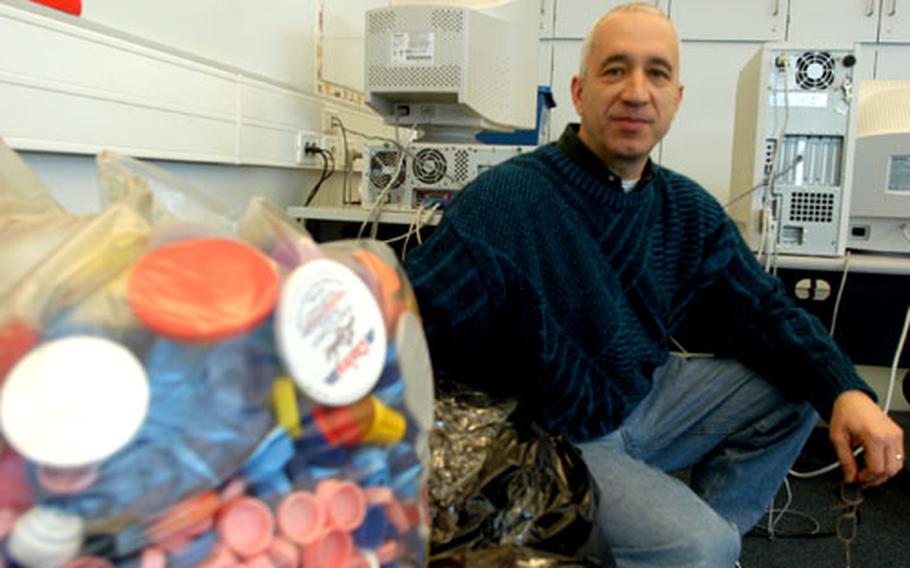 Joe Russo, a third-grade teacher at Aviano Elementary School, coordinates an effort by the Aviano military community to collect plastic bottle caps to raise money for a local nonprofit organization that houses cancer patients and their families.