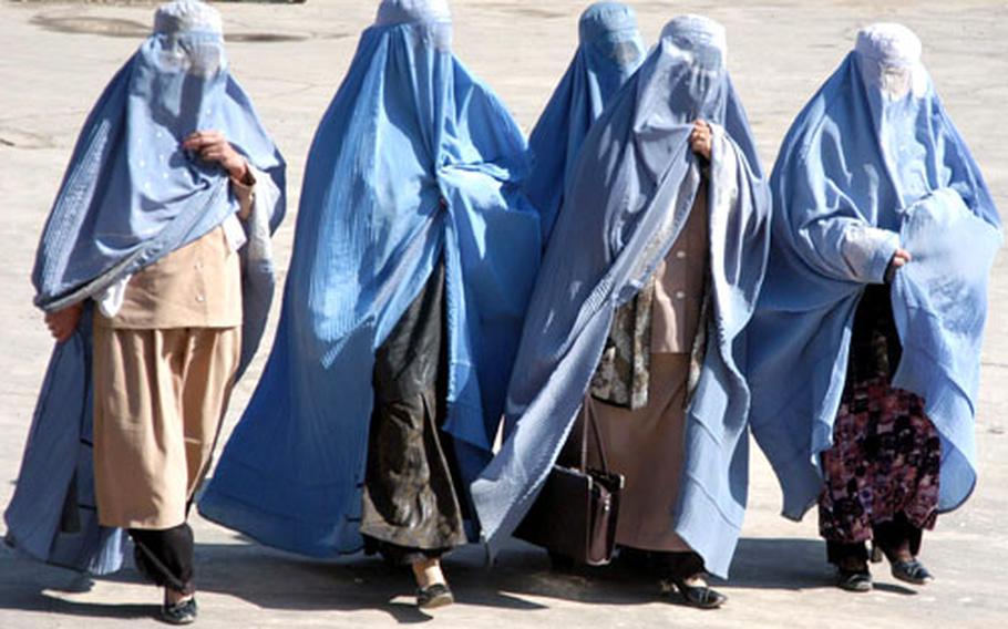 A group of Afghan women make their way to Albirooni University on Thursday to hear a series of speakers touting women&#39;s rights.