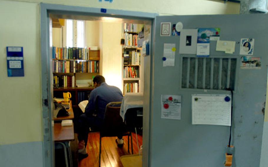 A U.S. inmate sits in his cell. U.S. inmates get their own cells and are allowed to own books, televisions and video players.
