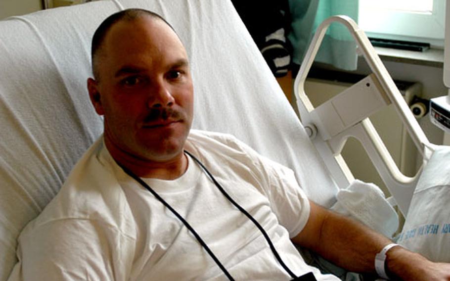 Sgt. 1st Class Kris Barrett, 37, of the 119th Field Artillery Battalion of the Michigan National Guard, was flown from Baghdad to Landstuhl Regional Medical Center in Germany recently after experiencing chest pains while guarding Abu Ghraib prison. Doctors discovered one of Barrett&#39;s arteries was 95 percent blocked and sent him to Walter Reed Army Medical Center in Washington D.C. for further treatment.
