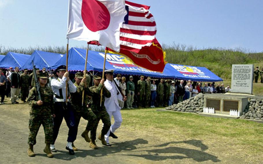 A joint Japan-U.S. color guard presents the nations&#39; flags during the Battle of Iwo Jima 60th anniversary commemoration on the island Saturday. Every year on March 12, U.S. and Japanese veterans, their families and officials meet on the island to pay tribute to those who lost their lives in the bloody battle.