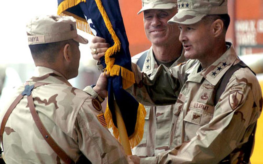 Outgoing Combined/Joint Task Force-76 commander Maj. Gen. Eric Olson, center, smiles as Combined Forces Command-Afghanistan commander Lt. Gen. David Barno, right, passes the task force colors to the new commander of CJTF-76, Maj. Gen. Jason Kamiya during the transfer of authority ceremony at Bagram Air Base, Afghanistan on Tuesday.