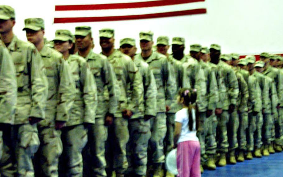 Emiluz Davila, 5, approaches her father, Sgt. Manuel Davila, at a welcome-home ceremony for the 272nd Military Police Company on Monday evening in Mannheim, Germany. Almost 150 soldiers returned from Iraq following a yearlong deployment.