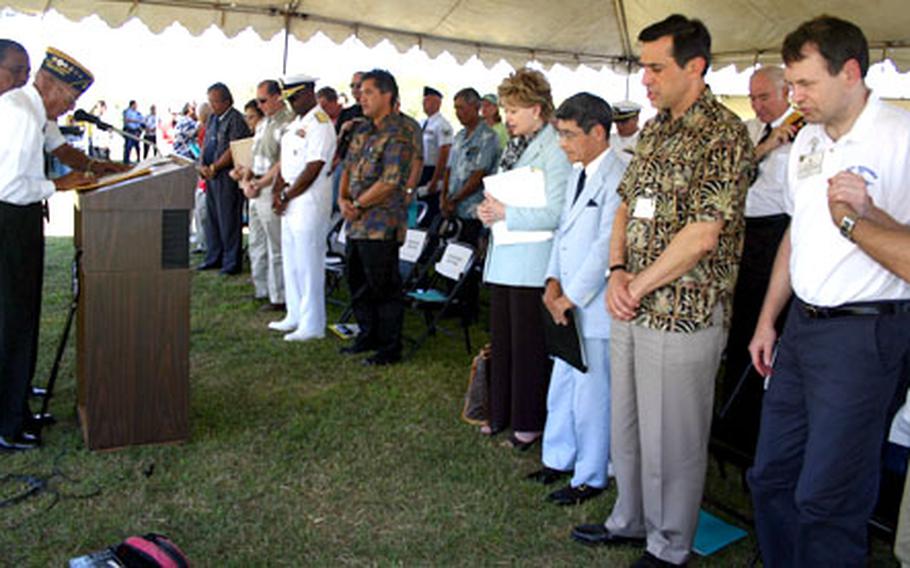 Jorge Cristobal, a Marine veteran from Guam who survived the attack on Pearl Harbor and took part in the retaking of Guam, concludes his speech with a prayer Monday at the dedication of the Baza Gardens Trimble Baseball Field in Yona.