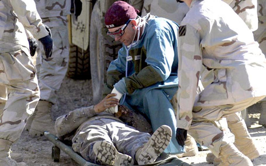 A wounded Iraqi soldier is treated by medics from Company C, 203rd Forward Support Battalion, 3rd Brigade Team, 42nd Infantry Division, after a car bomb exploded Wednesday morning in Baqouba, Iraq.
