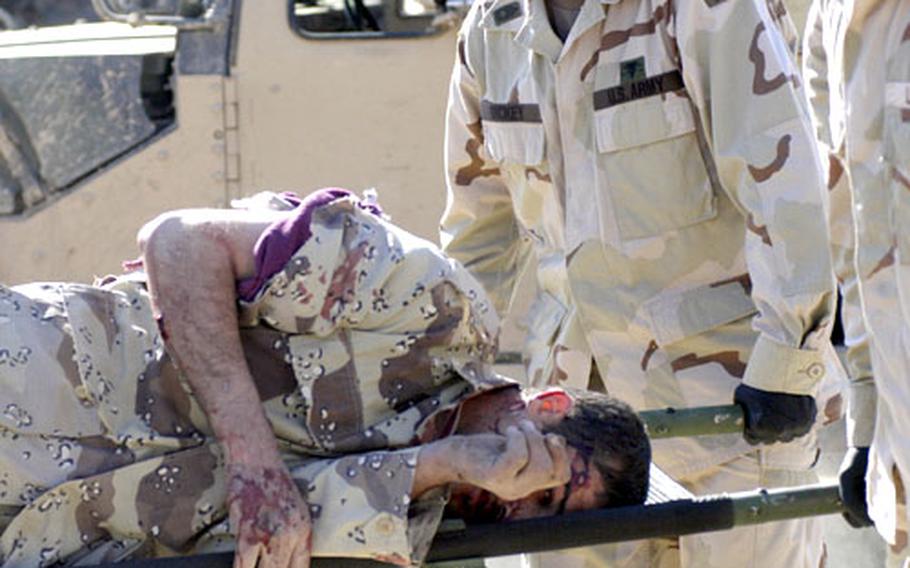 A wounded Iraqi soldier is carried on a stretcher by American medics.