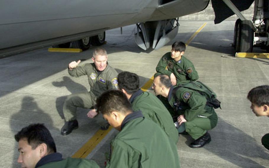 Chief Master Sgt. Sam Geros briefs Japanese Air Self Defense Force pilors before boarding the KC-135 refueling aircraft Tuesday.