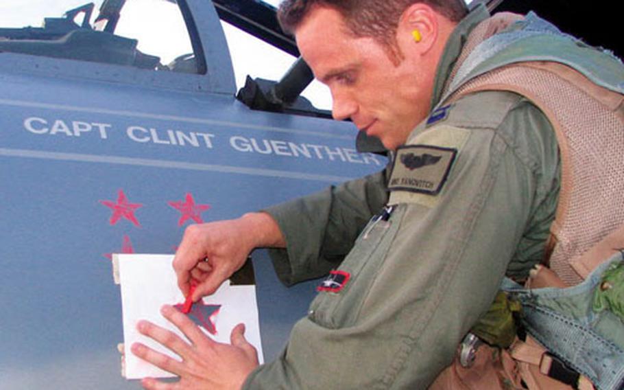 Capt. Mike Yanovitch of the 67th Fighter Squadron chalks up a "MiG kill" on an F-15 following a recent Operation Red Flag mission at Nellis Air Force Base, Nev. Fourteen F-15 pilots from Kadena Air Base, Okinawa, deployed to Red Flag to improve their combat skills.