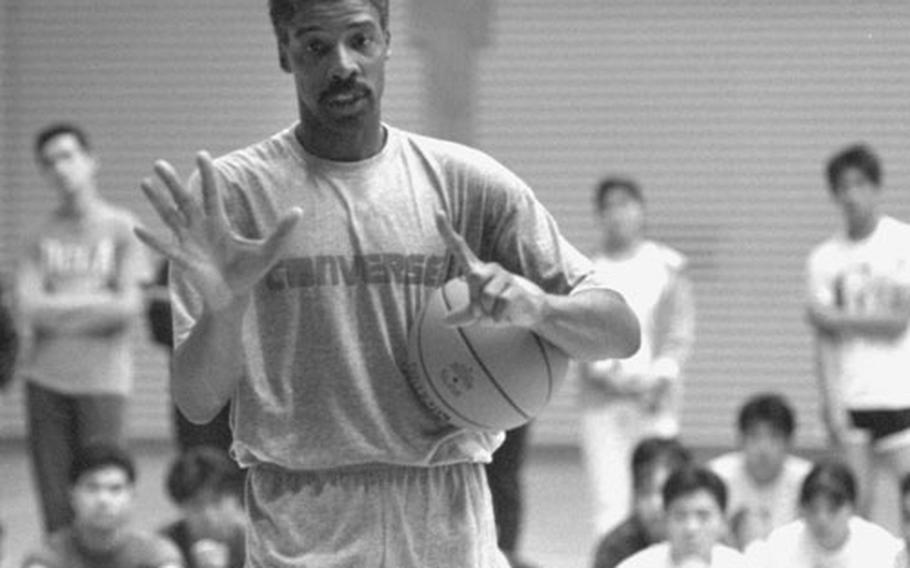 Julius Erving speaks at a basketball clinic in Tokyo in 1990.
