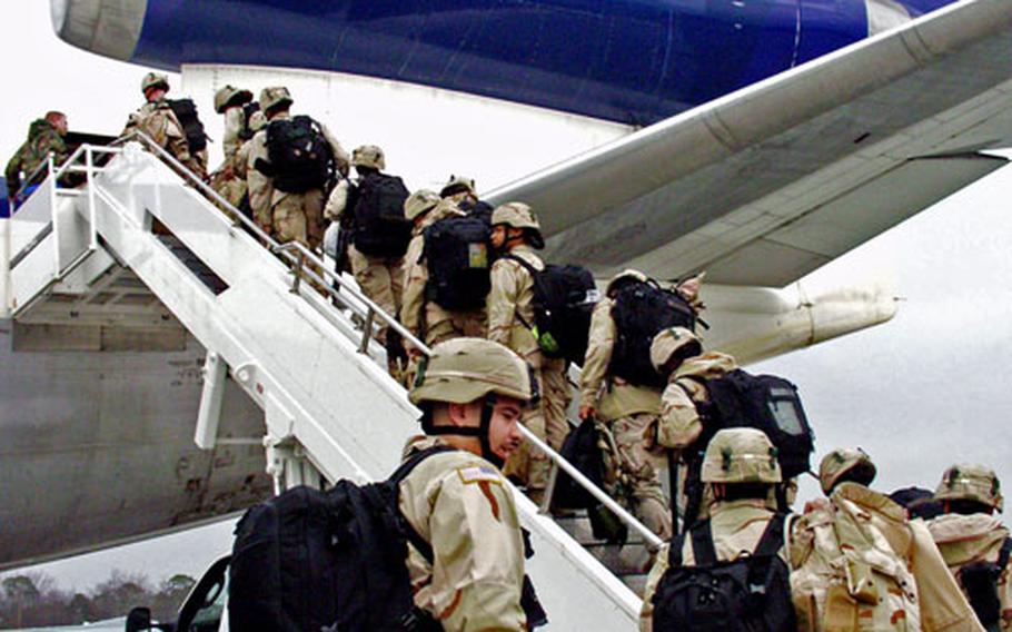 21st TSC Soldiers load onto a commercial airliner Saturday at Ramstein Air Base, Germany.