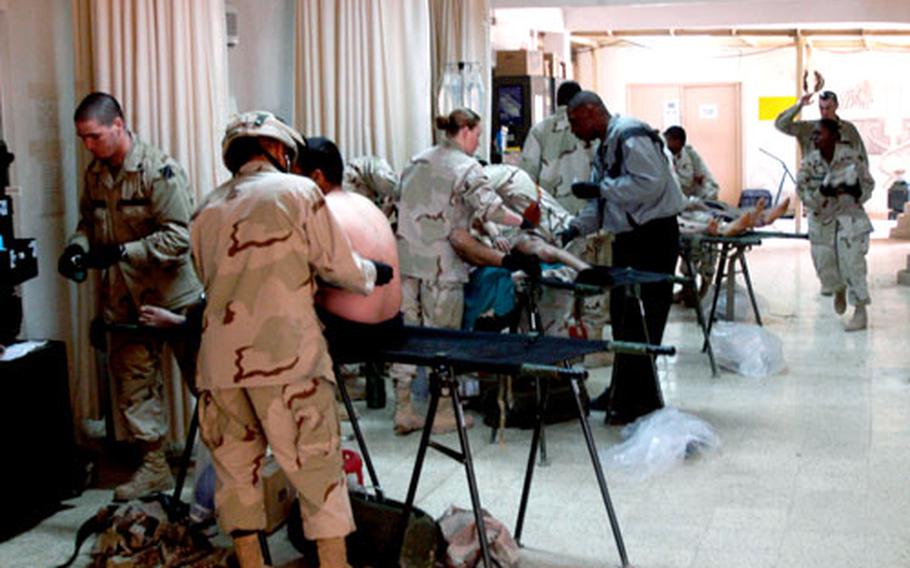 Soldiers from Company C, 203rd Forward Support Battalion, treat casualties Wednesday morning.