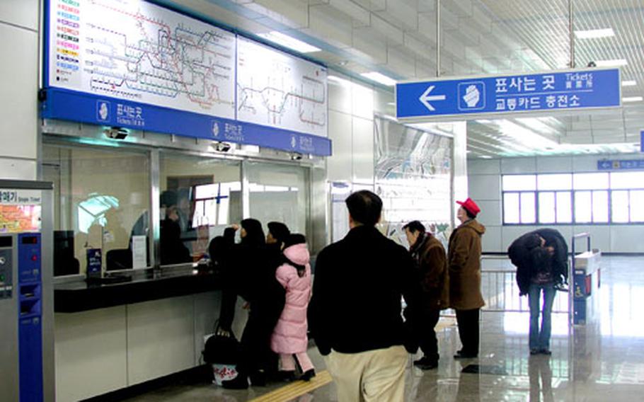 Patrons buy train tickets on the first day of Metro subway service in Songtan, near Osan Air Base in Pyongtaek, South Korea, in January. Since then, base officials have begun weekend subway trips in which they take servicemembers on trips to key cities and points of cultural interest in the region.