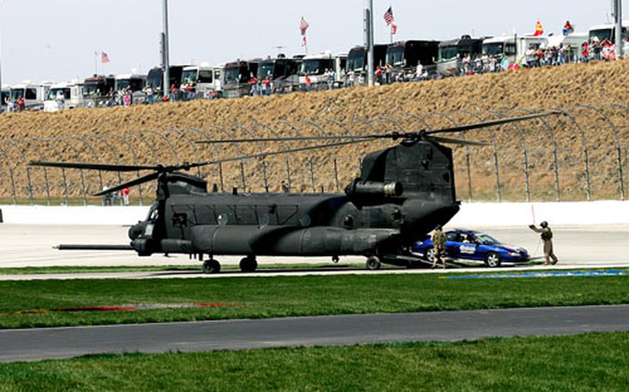 The pace car is unloaded from the rear of an MH-47 Chinook helicopter prior to the start of Sunday&#39;s NASCAR race at Atlanta Motor Speedway. The helicopter was flown by members of the Fort Campbell, Ky.-based 160th Special Operations Aviation Regiment (Airborne).