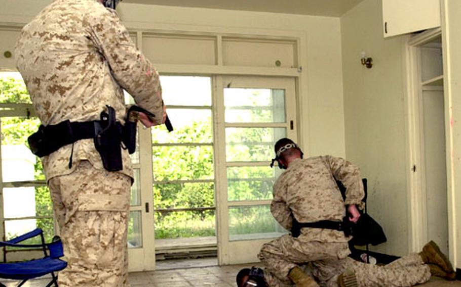 Marine military policemen "apprehend" a suspect in the old Sada Housing area during training on Tuesday.