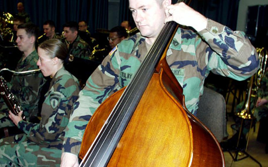 Sgt. 1st Class Larry Tilby plays the string bass during practice at Tompkins Barracks in Schwetzingen, Germany, on Thursday.