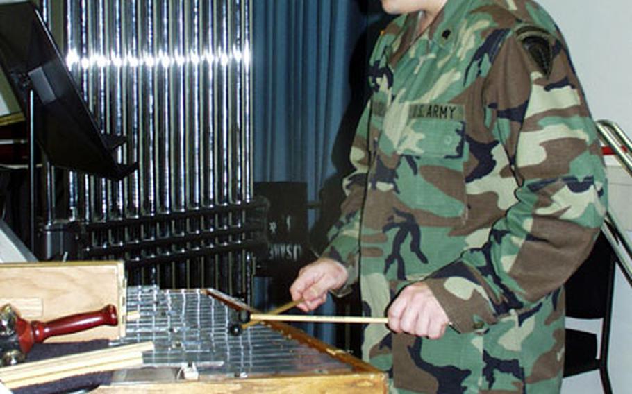 Spc. Stephen Schultz, a percussionist with the USAREUR band, plays a tune on the metal xylophone during rehearsal for the the spring concert, "Sounds of Liberty" practice on Tompkins Barracks on Thursday.