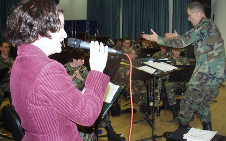 Jennifer Piazza-Pick, a soprano singer and wife of a band member, practices with the U.S. Army Europe Band during rehearsal on Thursday.