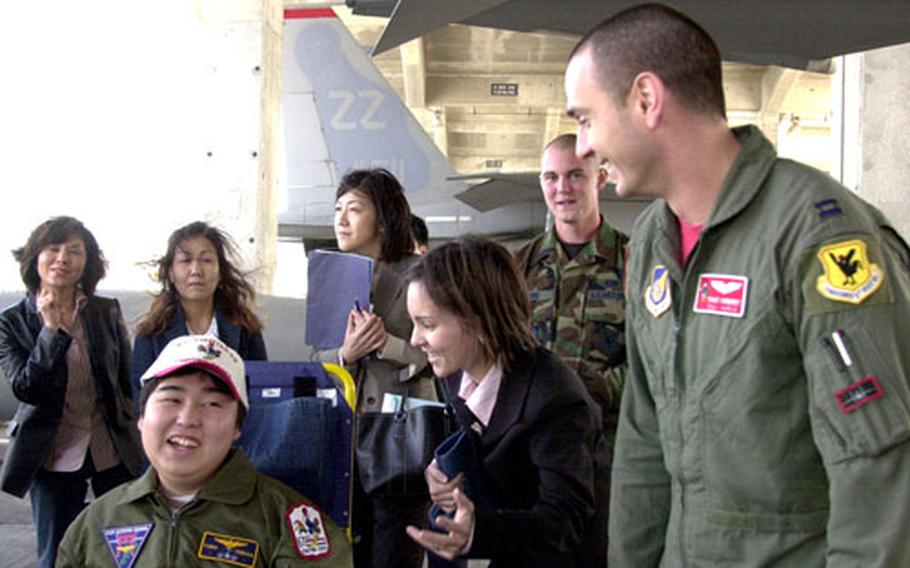 Yuma Tanaka, 18, left, tours an F-15 with Capt. Tony “Stab” Hebert, right, Friday at Kadena Air Base, Okinawa. Tanaka’s trip was made possible by Make-A-Wish Foundation Japan, the Air Force and the Navy.
