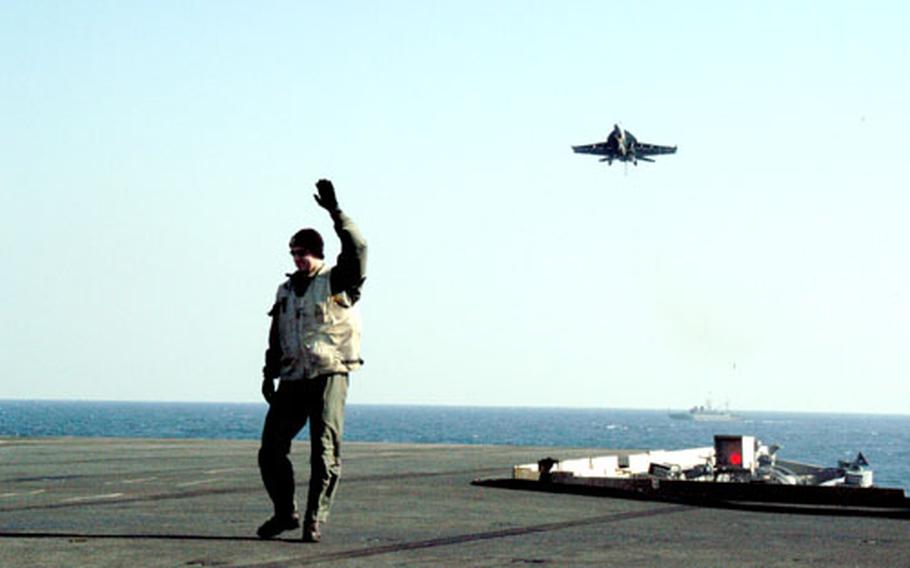 Landing signal officers stand on a platform at the back of the carrier to guide the aircraft in. Signal officers also stop jets from landing if any obstacles are on the flight deck and help determine what aircraft is landing to set the proper tension on the arresting gear. “Hands up” tells the approaching pilots the deck is not ready for a landing.