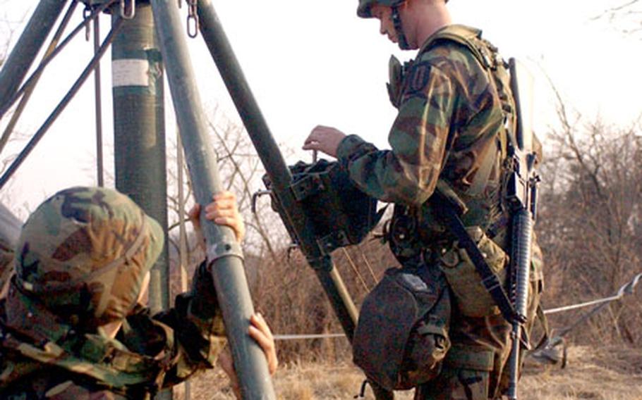 Soldiers from the 304th Signal Battalion erect tactical FM antennas on Hilltop 448, near Yongin.