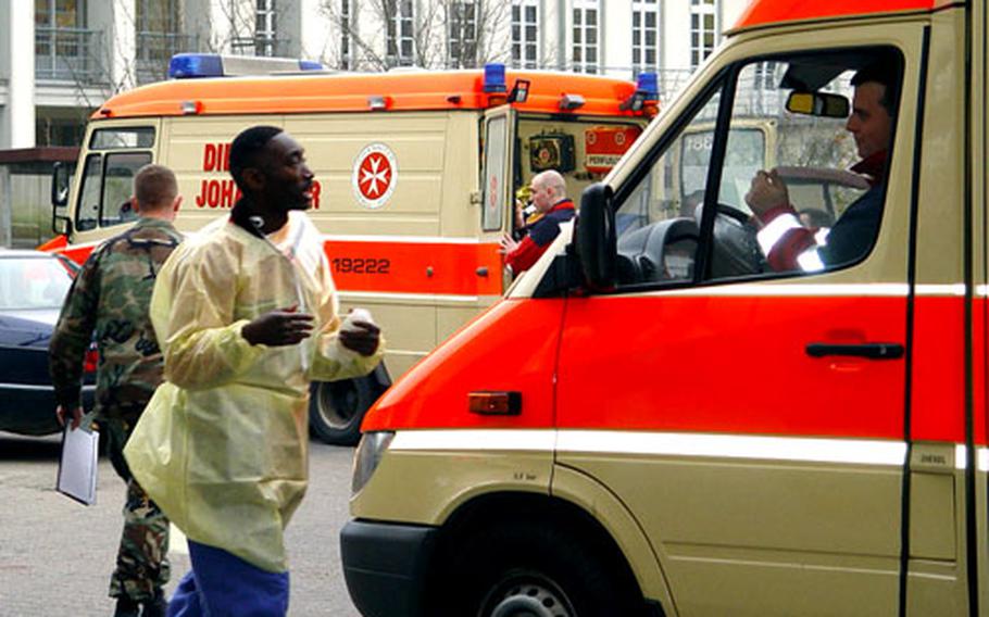 Staff Sgt. Quincy Belton of the 348th General Hospital talks to an ambulance driver outside the 67th Combat Support Hospital in Würzburg, Germany.