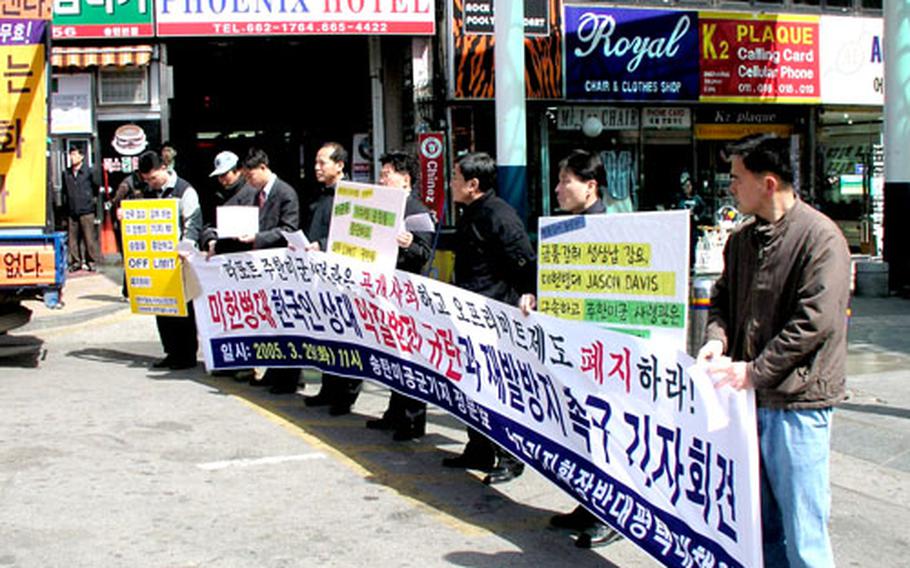 Demonstrators outside Osan Air Base, South Korea, on Tuesday protest what they say were shakedowns of local Korean bar owners by U.S. Air Force security police responsible for patrolling the off-base bar district.