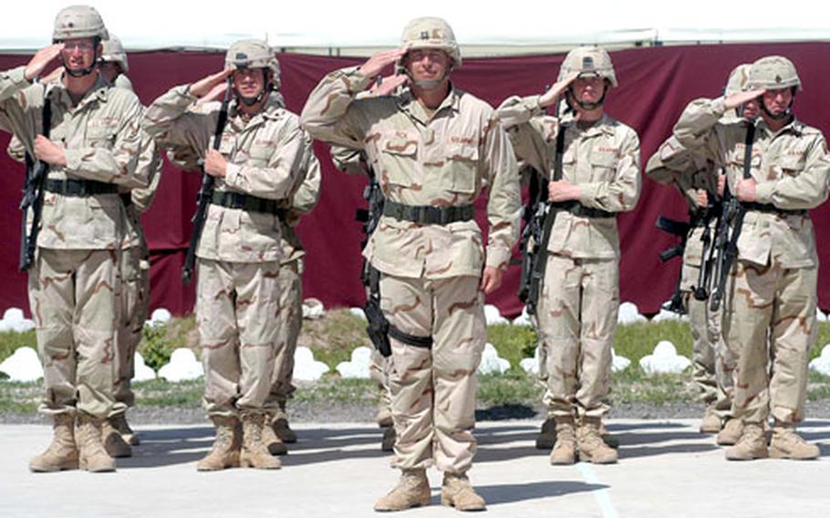 American soldiers salute during the playing of the national anthem during the transfer of authority ceremony on Thursday.