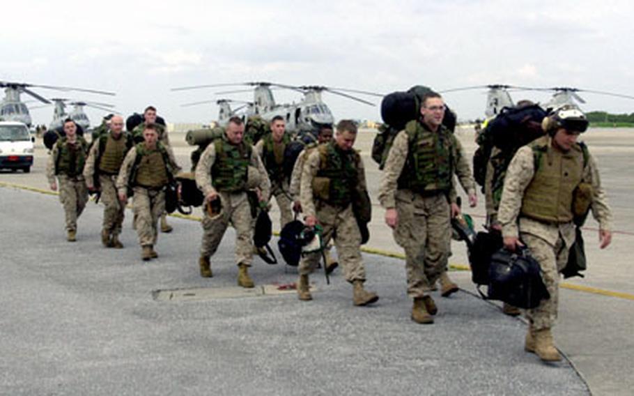 Members of Marine Medium Helicopter Squadron 265 arrive Friday at Marine Corps Air Station Futenma on Okinawa, completing a return voyage from Iraq where they had been deployed for six months.