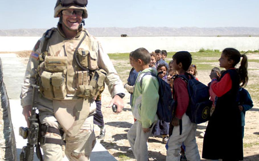 Master Sgt. Kevin Lieberman of Hacienda Heights, Calif., and the 426th Civil Affairs Battalion gets a chuckle from some young admirers during an inspection of a soccer stadium in Al-Alam, Iraq.