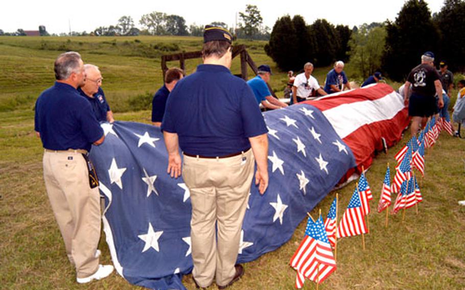 Members of GI Joe Post 244 in Jeffersontown, Ky., prepare the flags to be retired during the ceremony in 2003.