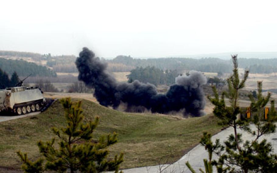 A plume of smoke rises from the explosion of a bangalore torpedo, which 54th Engineer Battalion soldiers used to clear a barbed wire obstacle during training Tuesday at Grafenwöhr Training Area.