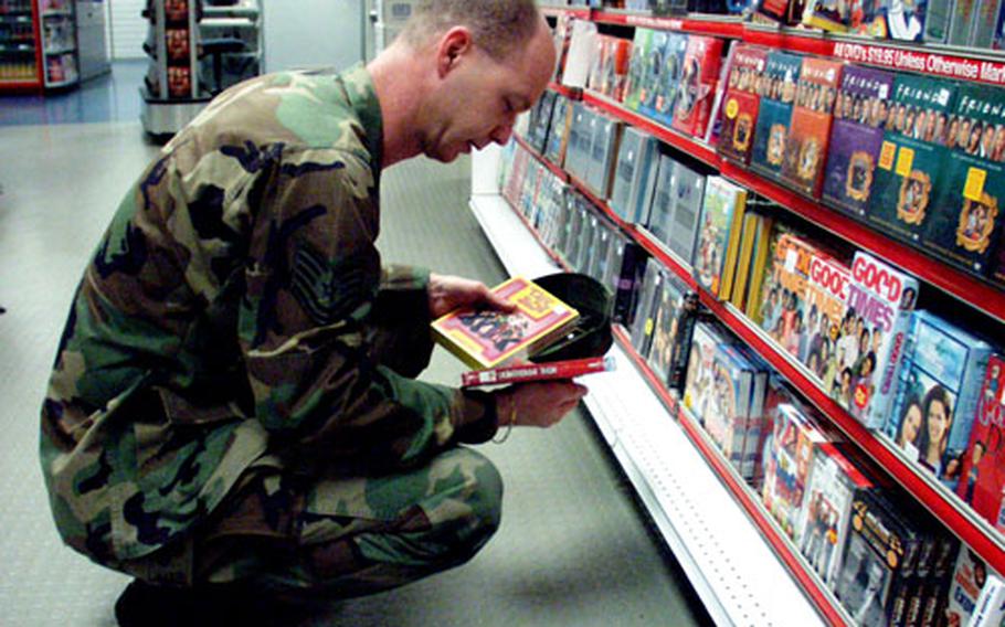 Air Force Tech. Sgt. Rory Townsend ponders what television series he wants to add to his growing collection of TV shows on DVD at the PowerZone at Vogelweh, Germany.