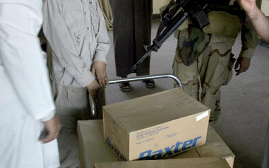 Dr. (Capt.) Mike Tarpey of Chicago and 1st Battalion, 15th Infantry Regiment, coordinates the unloading of medical supplies on Saturday at a clinic in Ad-Daluiyah, Iraq.