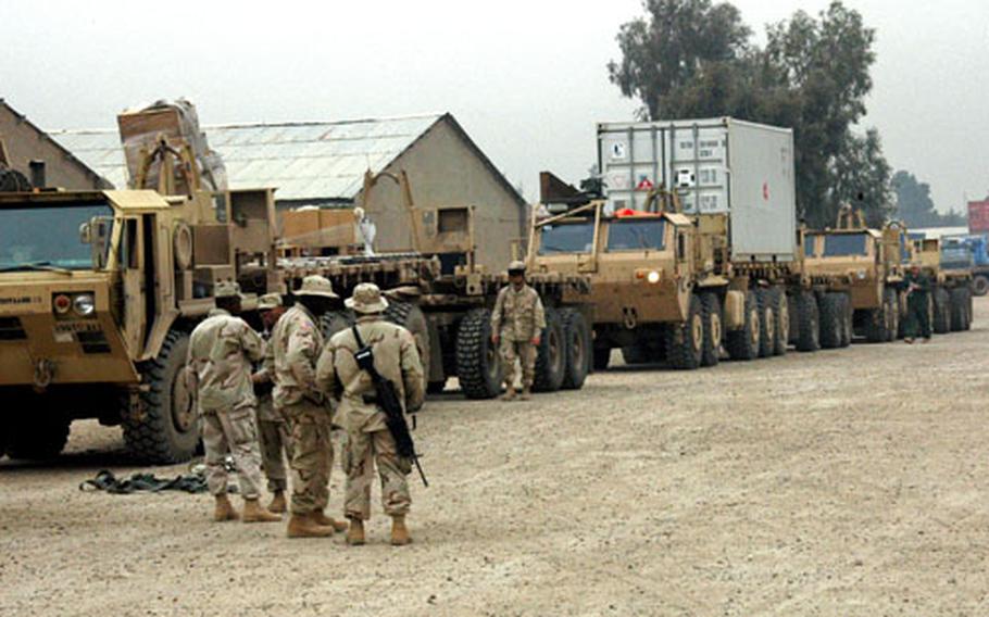 Soldiers from the 87th Corps Support Battalion, Division Support Brigade, part of the 3rd Infantry Division’s Task Force Baghdad, prepare a convoy last month at Camp Taji, Iraq. The unit hauls supplies from its massive distribution center to U.S. military installations and forward operating bases throughout Baghdad.