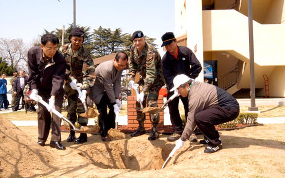 At Camp Henry in Taegu, South Korea, Tuesday, Oficials of the Nam-gu district of Taegu join Camp Henry officials in a tree-planting to mark South Korea&#39;s Arbor Day, a national holiday. The officials were guests of Army Col. Donald J. Hendrix, third from right, commander of the Area IV Support Activity at Camp Henry.