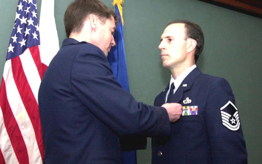 Master Sgt. Randolph Hodges receives the Airman’s Medal from 18th Wing Commander Brig. Gen. Jan-Marc Jouas for Hodges’ role in saving three men from drowning in the Gulf of Mexico in 2003. Hodges is now stationed at Kadena Air Base, Okinawa.