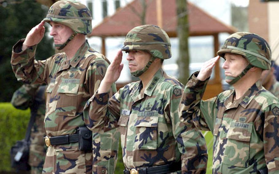 From left, Maj. Gen. Walter Wojdakowski, Lt. Gen. Ricardo Sanchez and Brig. Gen. Daniel Hahn salute during the playing of the national anthem at a farewell and welcome ceremony Wednesday in Heidelberg, Germany. Wojdakowski is the outgoing deputy commander for V Corps and Hahn is its incoming deputy commander. Sanchez is V Corps commander.