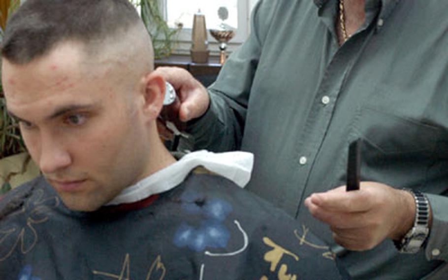Barber Giuseppe Muré puts the finishing touches on a $7.50 military buzz cut for Pfc. Dave Watson of Stuttgart, Germany’s 554th Military Police Company. Watson, a regular at Muré’s shop, said he wasn’t bothered that the Army and Air Force Exchange Service is raising the cost of a high-and-tight by 25 cents next month.