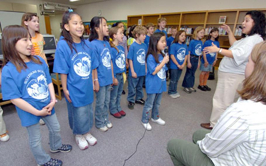 The Sullivans Elementary School choir sang the song “Everyday Heroes” at a ceremony Wednesday in which the Yokosuka Naval Base school&#39;s students presented a check for $6,052.86 to the United Nations Children’s Fund.