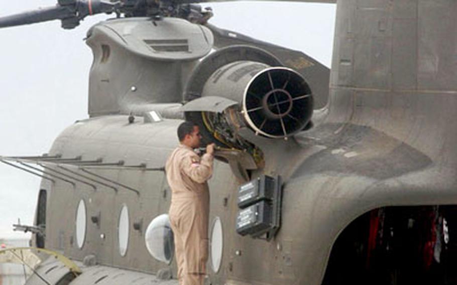 A member of Task Force Sabre pulls maintenance on a CH-47 Chinook helicopter at Bagram Air Base, Afghanistan.