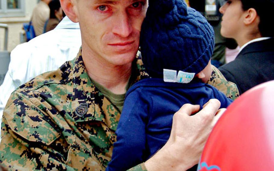 Gunnery Sgt. Randall Nace holds his newborn son R.J. on Wednesday at Sasebo Naval Base.
