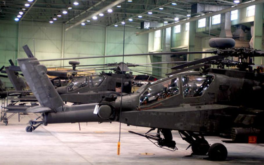 Newly arrived 1st Battalion, 2nd Aviation Regiment Apache helicopters rest inside a hangar at Camp Eagle, South Korea.