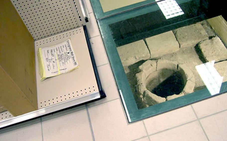 A Roman well sits below glass flooring in the new Naples Navy Exchange. In the commissary next door, a Roman oven sits between two rows of shelves. Archaeological excavations on the site recovered other items, including buried soldiers.