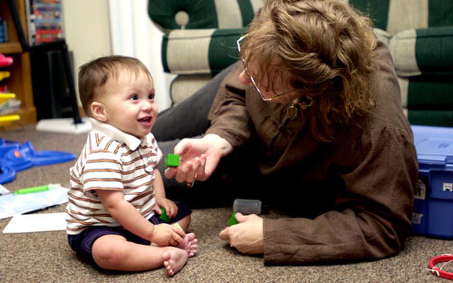 Terisa Ashofteh, a physical therapist, evaluates 9-month old Gnaeus Poulin in the family’s home on Kadena Air Base, Okinawa. Jennifer Poulin scheduled the evaluation for her son with the Early Intervention section of the Educational and Developmental Intervention Services after she realized he wasn’t “doing things he should be doing.”