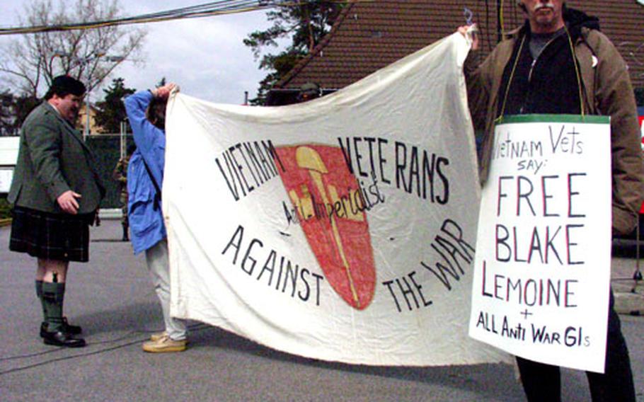Dave Blalock stands outside Coleman Barracks in Mannheim, Germany, Sunday afternoon to protest the confinement of Blake Lemoine.