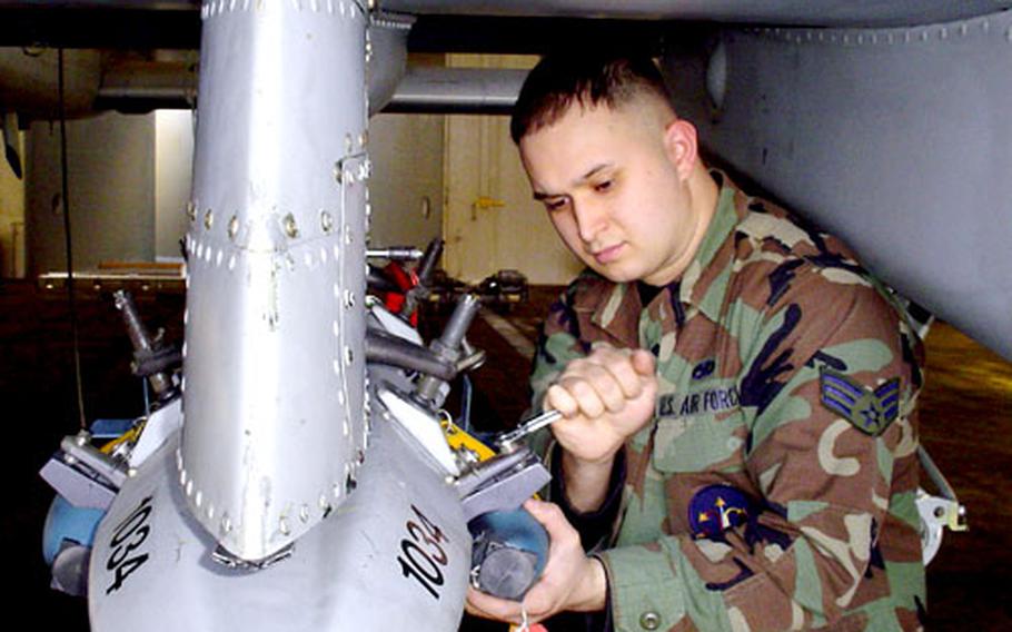 Senior Airman Michael Margiotta uploads a 25-pound BDU-33 practice bomb onto an A-10 at Spangdahlem Air Base, Germany.